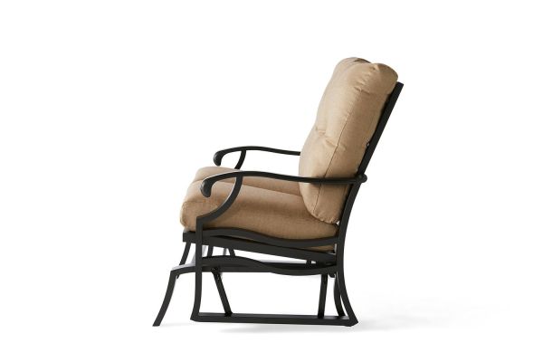 Side view of the Anthem Love Seat Glider, featuring a cushioned outdoor chair with a black metal frame and tan fabric cushions. It has a classic design, gently curved armrests, and a sturdy base, shown against a white background.