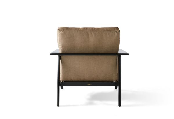 Back view of the Dakoda Cushion Lounge Chair with a beige cushion on a sleek black frame, set against a white background.