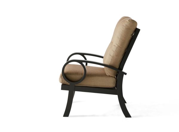 Side view of the Eclipse Dining Armchair, featuring a sleek black metal frame with curved armrests and a modern, minimalist design. It has beige cushions for the seat and backrest.