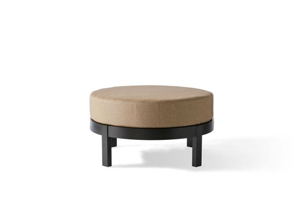 The Eclipse Circular Ottoman features a beige upholstered cushion atop a black circular wooden frame with four legs, set against a plain white background.