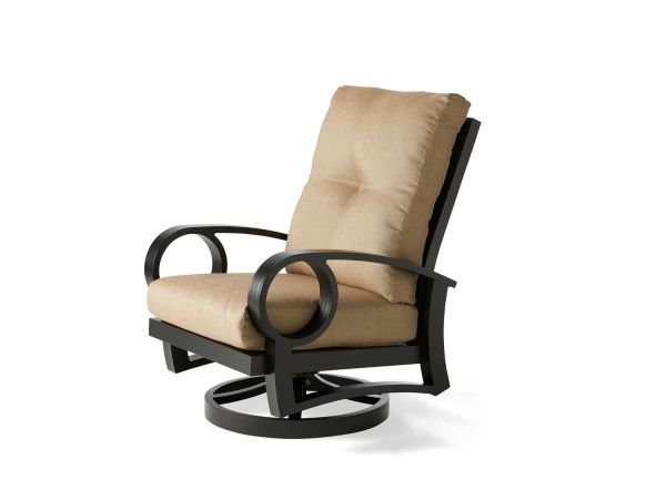 The Eclipse Swivel Rocking Dining Armchair combines comfort and style with its tan cushioned seat, sturdy black metal frame, curved armrests, and circular swivel base.