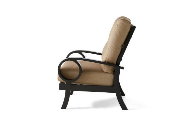 Side view of the Eclipse Lounge Chair, showcasing its sleek, minimalist design with a black metal frame, beige cushioned seat and backrest, and circular armrests.