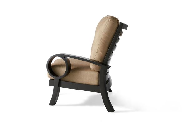 A side view of the Eclipse RAF Sectional End Unit showcases a modern look, featuring dark wood framing and beige cushioning on the seat and backrest. Circular armrests add a unique design touch. Its set against a white background.