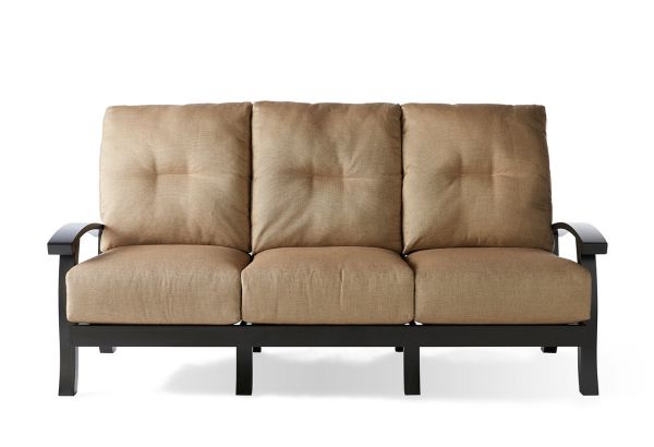 The Georgetown Cushion Sofa is a three-seater with tufted light brown cushions and features black metal armrests and legs, set against a white background.