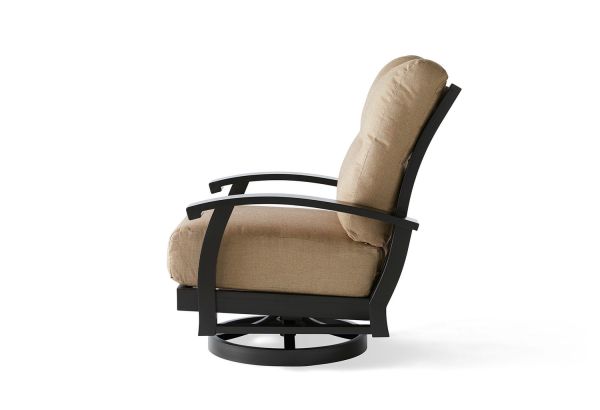 The Georgetown Cushion Spring Swivel Lounge Chair showcases a side view with a beige cushioned backrest and seat, elegantly supported by a black metal frame. The chair sits on a circular base, with slightly curved armrests enhancing its modern design.