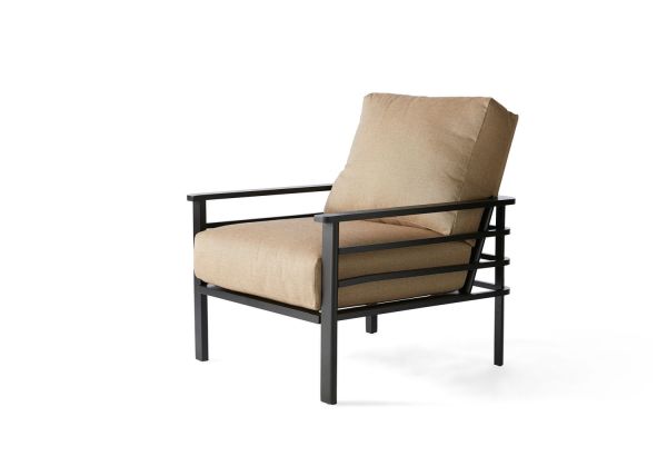 The Sarasota Cushion Lounge Chair boasts a modern, minimalist design with clean lines, featuring a dark metal frame and beige cushions that elegantly contrast the sturdy structure with soft upholstery.