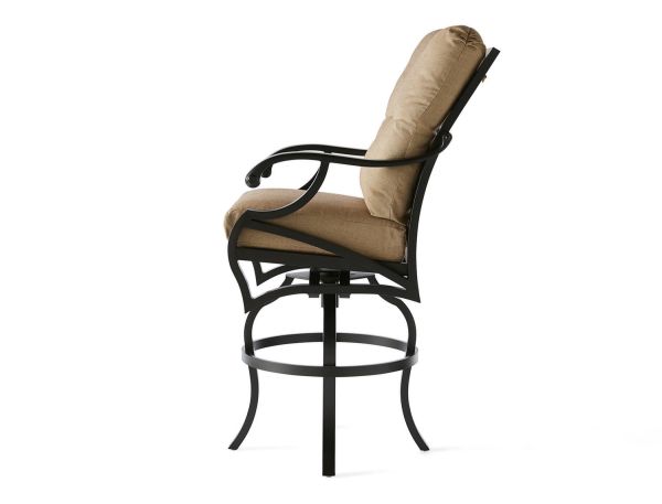 Side view of the Volare Cushion Bar Stool with beige cushions, a black metal frame, armrests, a curved backrest, and a circular footrest, set against a white background.