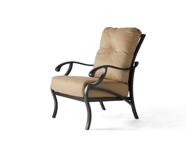 The Volare Cushion Lounge Chair features a beige fabric seat and backrest on a sturdy black metal frame with curved armrests and legs, offering soft comfort for indoor or outdoor use.