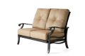 The Anthem Love Seat is a two-seater outdoor loveseat with a black metal frame, light brown cushioned seats with button tufts, and rounded armrests for added comfort.